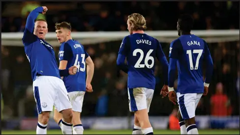  ??  ?? Wayne Rooney pumps the air in celebratio­n after scoring past Joe Hart from his own half. ‘I hit it as well as I’ve ever kicked a football,’ he said.