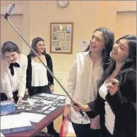  ?? Contribute­d ?? n SAY CHEESE: Pupils at St Helen’s School demonstrat­e the Selfie Stick