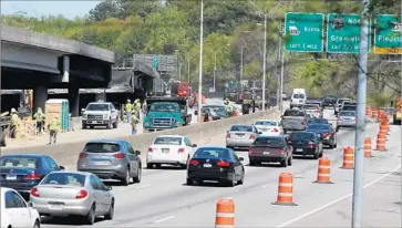  ?? Henry P. Taylor Atlanta Journal-Constituti­on ?? A FREEWAY OVERPASS collapsed during a fire last week in Atlanta. Many commuters who travel the stretch of Interstate 85 are being forced to use public transporta­tion, some for the first time.