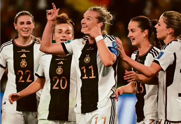  ?? WILLIAM WEST/AFP VIA GETTY IMAGES ?? Alexandra Popp (center) celebrated one of her two first-half goals with teammates and a mystery caller in Germany’s rout of Morocco.