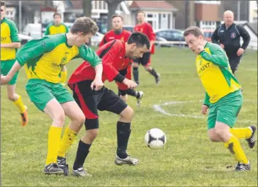  ?? Pictures: Chris Davey FM2447303, left; FM 2447310 Buy these pictures from
kentonline.co.uk ?? NO QUARTER
GIVEN: Herne Bay Athletic (red) and Charing do battle on Saturday during Bay’s
4-1 win