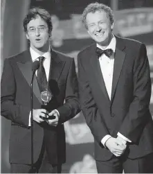  ??  ?? Don McKellar left, and Bob Martin after accepting the Tony for Best Book of a Musical at the Tony Awards in New York in 2006.