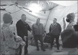  ?? Photos by Peter Loewi ?? LOCAL INPUT (top)— Charlie Lean, John Handeland, and Larry Pedersen speak with exercise participan­ts, during the National Guard’s Arctic Eagle exercise in Nome.