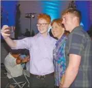  ?? BARB AGUIAR/Westside Weekly ?? Young Kelowna musician Elias Ord and Ian Roberts of Wales take a photo with Premier Christy Clark after her speech.