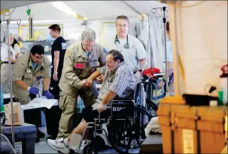  ?? ASSOCIATED PRESS ?? A PANAMA CITY RESIDENT, WHO DID NOT WANT HIS NAME USED, receives medical treatment inside the Florida 5 Disaster Medical Assistance Team tent, outside the Bay Medical Sacred Heart hospital, in the aftermath of Hurricane Michael in Mexico Beach, Fla., on Thursday.