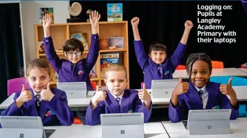  ?? ?? Logging on: Pupils at Langley Academy Primary with their laptops