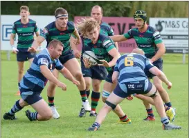  ?? ?? Clogher’s David Stinson bashes his way through the Dromore defence.