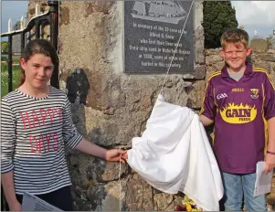  ??  ?? Emma Walsh and Harry McPhillips unveiling the Alfred D Snow plaque at Ballyhack cemetery.