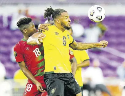  ?? (Photo: AP) ?? Jamaica defender Liam Moore (right) tries to head the ball in front of Suriname defender Kelvin Leerdam during the second half of their CONCACAF Gold Cup Group C football match in Orlando, Florida, on Monday, July 12, 2021.
