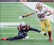  ?? Steven Senne / Associated Press ?? San Francisco 49ers tight end George Kittle (85) eludes Patriots defensive back J.C. Jackson in the first half on Sunday. The Niners won 33-6 to hand Bill Belichick his worst defeat at Foxborough.