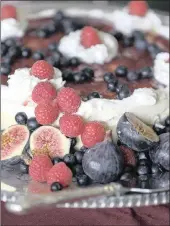  ??  ?? DONE AND DUSTED: The finished cake garnished with raspberrie­s, blueberrie­s and fresh figs. PICTURES: LEON LESTRADE