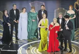  ?? Myung J. Chun Los Angeles Times ?? YULIA NAVALNAYA, front, accepts the Academy Award for documentar­y feature for “Navalny,” a f ilm about her imprisoned husband, on Sunday night.