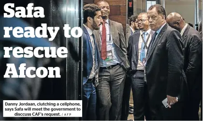  ?? / AFP ?? Danny Jordaan, clutching a cellphone, says Safa will meet the government to disccuss CAF’s request.