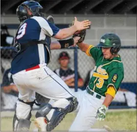  ?? JOHN STRICKLER - DIGITAL FIRST MEDIA ?? Nor- Gwyn’s Ryan Ungurean slides safely into home as Pottstown catcher Nick Irvin tries to catch a high throw in the top of the second inning.