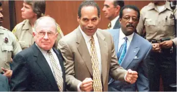  ?? MYUNG J. CHUN/LOS ANGELES DAILY NEWS VIA AP, POOL ?? ABOVE: In this Oct. 3, 1995, file photo, O.J. Simpson reacts as he is found not guilty in the death of his ex-wife Nicole Brown Simpson and her friend Ron Goldman in Los Angeles. Defense attorneys F. Lee Bailey, left, and Johnnie L. Cochran Jr. stand with him.