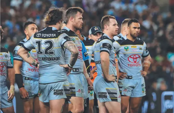  ?? Picture: ADAM HEAD ?? AT A LOSS: A disappoint­ed Cowboys team after their loss to Melbourne Storm in the NRL grand final on Sunday will use the experience as fuel to fire up their campaign next season.
