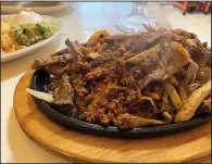  ?? Arkansas Democrat-Gazette/ERIC E. HARRISON ?? Chicken, steak, chorizo and shrimp are the four meats in the 4 Meat Lupita’s Fajitas at Three Amigo’s Restaurant­e.