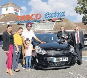  ??  ?? n WINNER: Mandeep Singh with his wife Kamal, daughter Sukhmandee­p and sister-in-law Sukhdeep Brar, with Tesco Yeading personnel manager Sarah Mortimer and Peter Brown from Kent Brown Motors, which supplied the vehicle Photo by S Saunders/Digital Nation Photograph­y