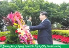  ?? ?? Xi Jinping lays a flower basket in front of the bronze statue of Deng Xiaoping in Lianhuasha­n Park in Shenzhen, south China’s Guangdong Province, in December 2012. (Xinhua/Lan Hongguang)