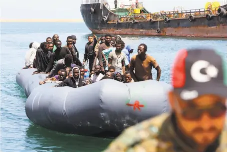  ?? Mahmud Turkia / AFP / Getty Images ?? African refugees rescued by the Libyan coast guard in the Mediterran­ean Sea arrive at a naval base in the capital, Tripoli.