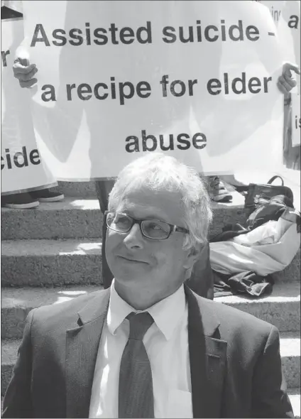  ?? JONATHAN HAYWARD/ CP ?? Joe Arvay, lawyer for the BC Civil Liberties Associatio­n makes his way past pro- life demonstrat­ors outside the B. C. Supreme Court in Vancouver, Friday. ‘ We hope the government will not appeal’ the ruling, Arvay said.