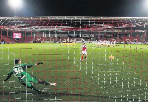  ??  ?? Chris Clements sends Newport keeper Nick Townsend the wrong way during the shootout