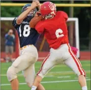  ??  ?? Team Freedom’s Mitch Bradford (6) and Team American’s Michael Felix go up for a pass during the second half. The ball fell incomplete.