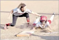  ?? RICK PECK/MCDONALD COUNTY PRESS ?? McDonald County first baseman Maddie Colvin is just a fraction of a second late in putting a tag on an Aurora runner during the Lady Mustangs’ 12-0 win on Aug. 31 at MCHS.