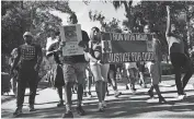  ?? NEWS VIA THE ASSOCIATED PRESS] ?? A crowd marches through a neighborho­od, Tuesday, in Brunswick, Ga. They were demanding answers in the death of Ahmaud Arbery. [BOBBY HAVEN/ THE BRUNSWICK