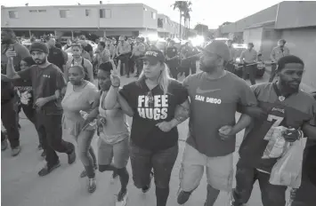  ?? AGENCE FRANCE PRESSE ?? Protesters march through the street during a rally in El Cajon, a suburb of San Diego, California on Wednesday, in response to the police shooting of an unarmed black man, said to be mentally ill, the night before.