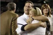  ?? BRETT FLASHNICK — THE ASSOCIATED PRESS ?? In this Oct. 1, 2011, file photo, Auburn head coach Gene Chizik, left, embraces his wife Jonna Chizik, after his team’s 16-13 victory over South Carolina in an NCAA college football game, at Williams-Brice Stadium, in Columbia, S.C.