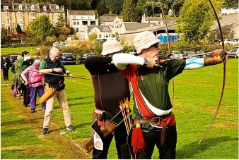  ?? ?? Paul Tuffs (foreground) takes aim at the Two-way Longbow event