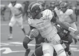  ?? KARL MERTON FERRON/BALTIMORE SUN ?? New Era Academy defender Elijah Nelson tries to bring down Green Street Academy quarterbac­k Keyontae Rheubottom during the Ravens RISE Showdown on Friday.