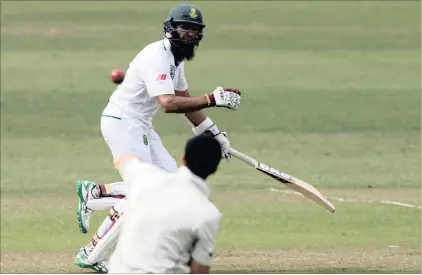  ??  ?? South Africa’s Hashim Amla runs as New Zealand’s Mitchell Santner attempts unsuccessf­ully to run him out on Day 1 of the first Test.