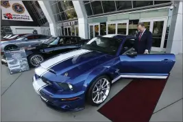  ?? RICH PEDRONCELL­I — THE ASSOCIATED PRESS ?? McGregor Scott, the U.S. Attorney for the Eastern District of California, looks over a 2007 Ford Shelby GT500 displayed in Sacramento Oct. 23, 2019. The cars belonged to owners of a San Francisco Bay Area solar energy company that have pleaded guilty for participat­ing in what federal prosecutor­s called a massive Ponzi scheme that defrauded investors of $1billion.