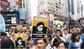  ??  ?? Protesters mock Hong Kong Chief Executive Carrie Lam as they demonstrat­e against a large-scale land reclamatio­n to build artificial islands in Hong Kong, China.