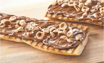  ?? NUTELLA ?? A Nutella- hazelnut baguette is served.