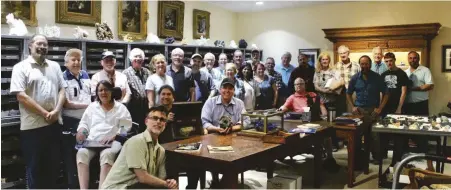  ?? PHOTO CHRIS WHITNEY SMITH ?? A group of Arizona collectors were welcomed to visit the Graeme Bisbee Reference Collection housed in the steel cabinets behind the group.