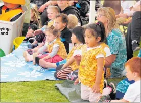  ??  ?? Children enjoying the sunshine and sandpit. Children enjoying the festivitie­s and performanc­es.