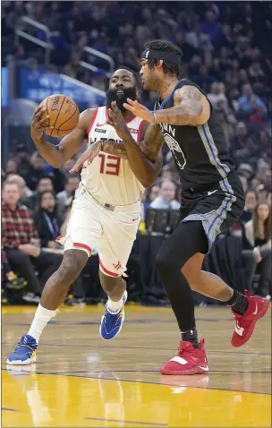 ?? TONY AVELAR — THE ASSOCIATED PRESS ?? Houston Rockets guard James Harden (13) dribbles around Golden State Warriors center Willie Cauley-Stein (2) during the first half Wednesday in San Francisco.