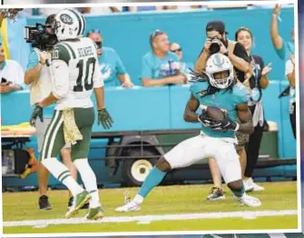  ?? AP ?? A fourth quarter pass intended for Jermaine Kearse is picked by Dolphins DB Walt Aikens (inset).