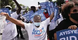  ?? CARL JUSTE cjuste@miamiheral­d.com ?? Haitian American supporters of Democratic presidenti­al nominee Joe Biden dance and cheer as they lined the streets of Northeast Second Avenue and 59th Terrace in Little Haiti hoping to catch a glimpse of the visit of the candidate on Monday.