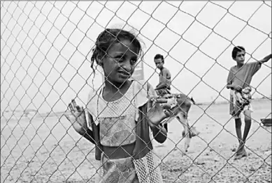  ??  ?? A girl looks through the fence of a closed clinic at a camp for internally displaced people near Abs of Hajjah province, Yemen August 19, 2020. Picture taken August 19, 2020. (Photo:Reuters)