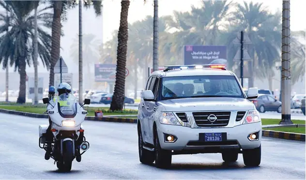  ??  ?? ↑
Sharjah Police patrol a street in the emirate.