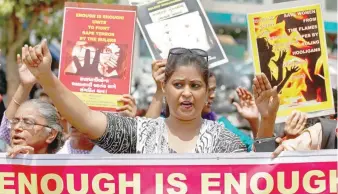  ??  ?? People hold placards at a protest against the rape and murder of an eight-year-old girl in Kathua and a teenager in Unnao, in Ahmedabad on Friday. — Reuters