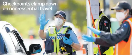  ?? PHOTO / MICHAEL CUNNINGHAM ?? Police signal a driver to stop at a checkpoint on State Highway 1 near Mangawhai yesterday.