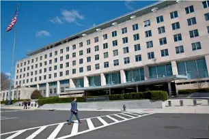  ?? People walk near the uS State Department in Washington on Monday. the White house says the expulsion of russian diplomats and closure of the russian consulate in Seattle will “make the united States safer.” — AP ??