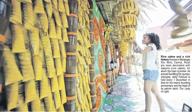  ?? PHOTOGRAPH BY ANALY LABOR FOR THE DAILY TRIBUNE @tribunephl_ana ?? Rice cakes and a rich history Houses in Barangay Sto. Niño, Cainta, Rizal are seen decorated with kakanin (rice cakes), for which the town is known. Its annual SumBingTik (suman, bibingka, latik) Festival is held every 1 December in time for the town’s founding anniversar­y and the feast of its patron saint, Our Lady of Light.