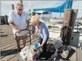  ?? DANA JENSEN/THE DAY ?? Guylaine “Sky” Nicol, right, of Stonington and Captain Sequoia Sun look at donations that New England Science and Sailing staff collected for Haiti at NESS’s dock in Stonington Tuesday.