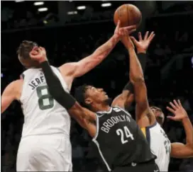  ?? JULIE JACOBSON — THE ASSOCIATED PRESS ?? Brooklyn’s Rondae Hollis-Jefferson (24), of Chester, reaches for a rebound against Utah’s Jonas Jerebko (8) and guard Donovan Mitchell (45) during the first quarter Friday in New York.